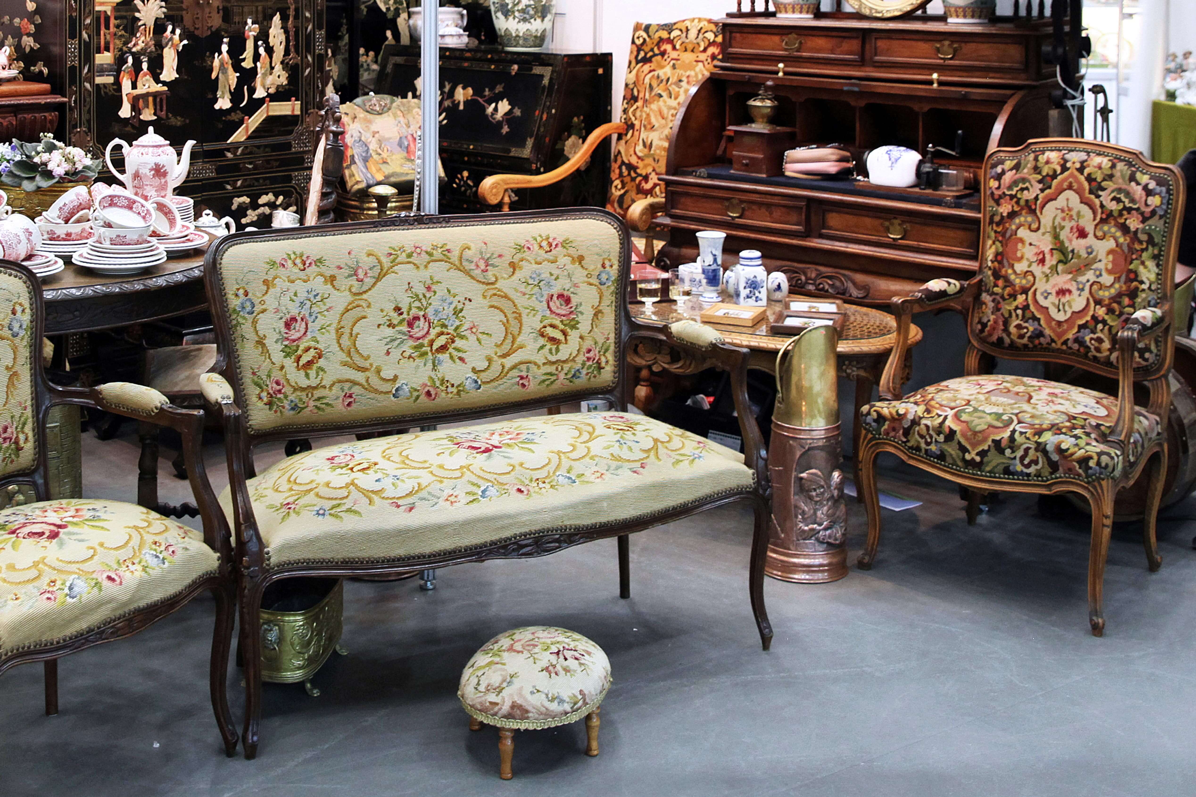 Estate sale with antique furniture, china, and other collectibles for auction